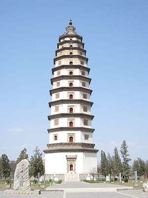 An eleven story octagonal pagoda crowned with a large bronze and iron spire. Each floor has a carved stone eave that serves as a functional, all be it small, balcony. The building is painted white.
