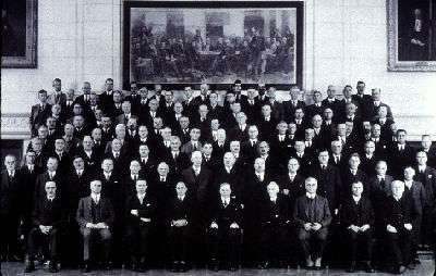 Approximately fifty men seated for a group photograph