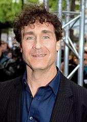 Doug Liman in front of a steel beam.