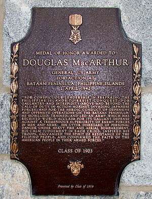 A bronze plaque with an image of the Medal of Honor, inscribed with MacArthur's Medal of Honor citation.