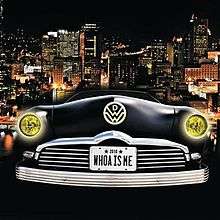 A city skyline at night is shown as the background. The front of a black-colored vehicle shows the headlines on, the band logo and a license plate with the song title on it.