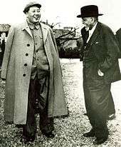 Du Bois standing outdoors, talking with Mao Tse Tung