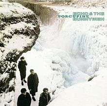 An album cover showing four men stood on a rocky outcrop with a frozen waterfall to their left. The band's and the album's names are in the top-left corner of the cover in green text.