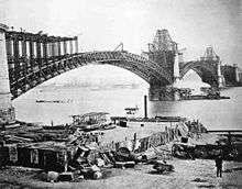 Photograph of the Eads Bridge under construction in 1874 showing its girders and piers