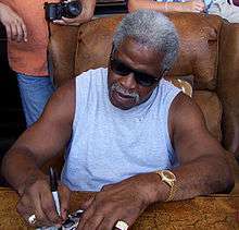 A picture of Earl Campbell on a phone.