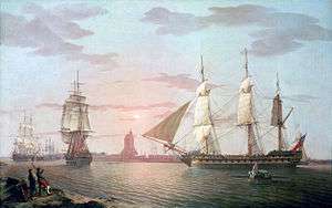 In front of a setting sun, three sailing ships make their way out of a harbour with their lower sails set. A rowing boat is heading towards the nearest ship and two men watch the scene from the foreground.