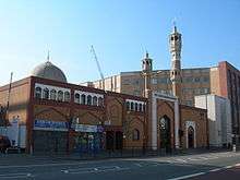 Colour photograph of the mosque and neighbouring buildings on Whitechapel Road