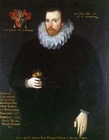 A portrait of a brunette man in his 40s, with a brunette beard and mustache. He is wearing a shapeless black robe and a Jacobean ruff; to the right of his head is a coat of arms with a motto underneath it. On the bottom right of the portrait is a paragraph of indistinguishable text, while the entire picture is captioned "Given by the descendent Thomas William Coke 1780+".
