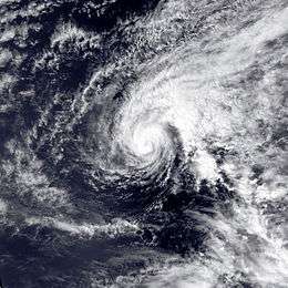 Satellite image of Hurricane Ekeka in open sea. The tropical cyclone is somewhat elongated in appearance and has a visible albeit inconspicuous eye
