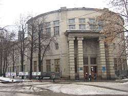 Round, gray Electrotechnical Building with high-pillared entrance