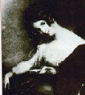 Seated woman, looking toward her left at artist, perhaps when interrupted while reading