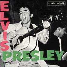 Album cover with photograph of Presley singing—head thrown back, eyes closed, mouth wide open—and about to strike a chord on his acoustic guitar. Another musician is behind him to the right, his instrument obscured. The word "Elvis" in bold pink letters descends from the upper left corner; below, the word "Presley" in bold green letters runs horizontally.