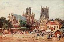 Watercolour The Market Place, Ely by W W Collins published 1908 showing north-east aspect of Ely Cathedral in the background with the Almonry in front of that and the now demolished corn exchange building to the right of the picture