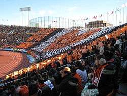 An orange heart is made out of a choreographic performance by fans at the stand.