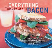 A double bacon, lettuce and tomato sandwich on a plate. Overlaid text reads: Everything Tastes Better with Bacon