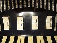 Set of two-way rocker switches (labeled LOW, HIGH, MIDDLE, MIDDLE) controlling individual reed ranks for the treble keyboard of an Excelsior accordion.