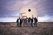The completed exterior of the station on July 26, 2000. From left to right are Joe Amarualik, Joannie Pudluk, John Kunz, Frank Schubert, Matt Smola, Bob Nesson and Robert Zubrin.