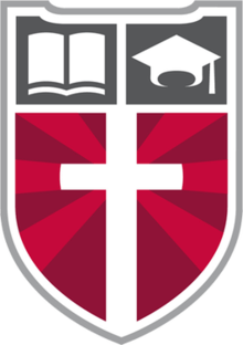 Faith Academy's logo, the "Shield of Faith," displaying a Christian cross and the school's motto.