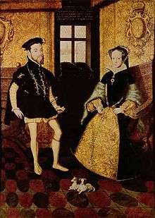 A painting in mostly black, yellow and red of a man and a woman in 16th century clothing sitting. There are two small mostly white dogs at the feet of the couple.