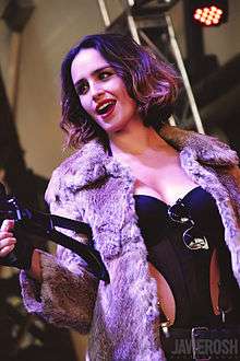 Smiling young woman in a skimpy costume and fur jacket