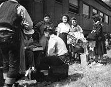 Japanese evacuees on August 30, 1942, arrive by train, wait for the bus ride to Camp Amache, Granada Relocation Center, southeastern Colorado.