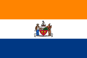 A flag with three equal horizontal stripes colored orange, white, and blue from top to bottom. In the center is the city seal (except for text and circular outline).