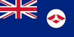 A British Blue Ensign (a blue flag with the Union Jack placed at the top left corner) charged with the badge of the Straits Settlements (red diamond with an inverted white Y; inside that inverted Y is three crowns.