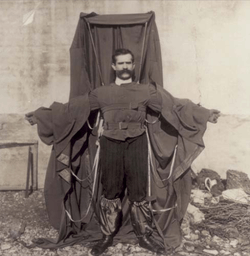 A man wearing a frame draped in material.