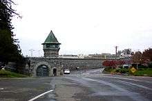 Photo of walls and guard towers of a prison.