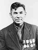 older man with suit, tie, and medals on his chest
