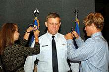 Gorenc, as commander of the Air Force District of Washington, receives two star epaulets from his children, during his promotion ceremony.