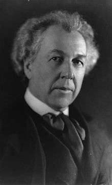 Black and white portrait photo of a white male with light hair