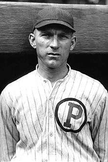 A man wearing a dark cap and a pinstriped baseball jersey with a "P" inside a circle on the left breast.