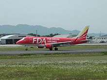 Fuji Dream Airlines Embraer 170 in red livery taking off at Kumamoto Airport