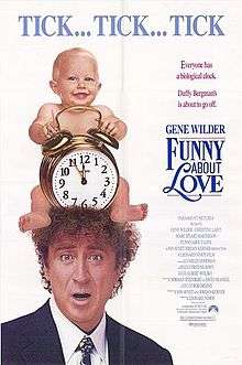 Gene Wilder has a confused look on his face as an infant sits on his head holding a clock