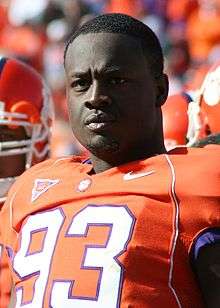 A man in an orange football uniform numbered 93.