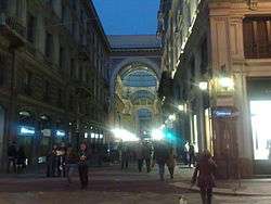 A gallery can be seen here in Milan at night.
