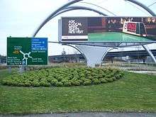 Grassy median, with billboard and road sign