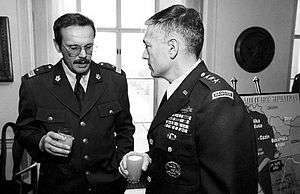 Generals Clark and Ćosić talking at a meeting