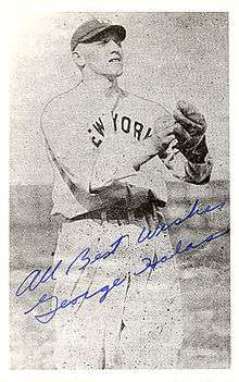 New York Yankees outfielder George Halas is pictured on a signed baseball card, waiting for the ball to land in his outstretched mitt.