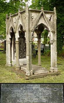 A granite gravestone in the shape of an empty deathbed surmounted by a Gothic-styled six-columned granite canopy
