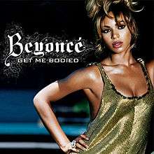 A woman is standing with her right hand on her hip. She is wearing a low cut green dress, and dark eye liner and hair piled high on her head. Next to her, the words "Beyoncé" and "Get Me Bodied" are written in white letters.