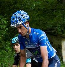 Beñat Intxausti riding uphill in the blue jersey of the leader of the mountains classification