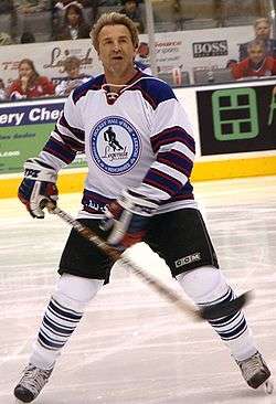 Glenn Anderson skating in full hockey gear (without a helmet).