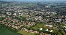 Aerial image of southern Glenrothes (looking northwest) showing housing estates, industrial areas, road networks and green spaces and landscaping in the town. The Lomond Hills can be seen to the north