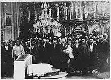 Men, women and children gathered in a church
