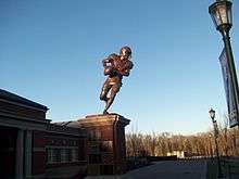 A bronze sculpture of an American football player