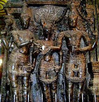 sculpture in temple column showing three figures