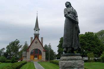 Statue of Longfellow's Evangeline (by Louis-Philippe Hébert) and memorial church.