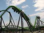 Green roller coaster preparing to go upside-down